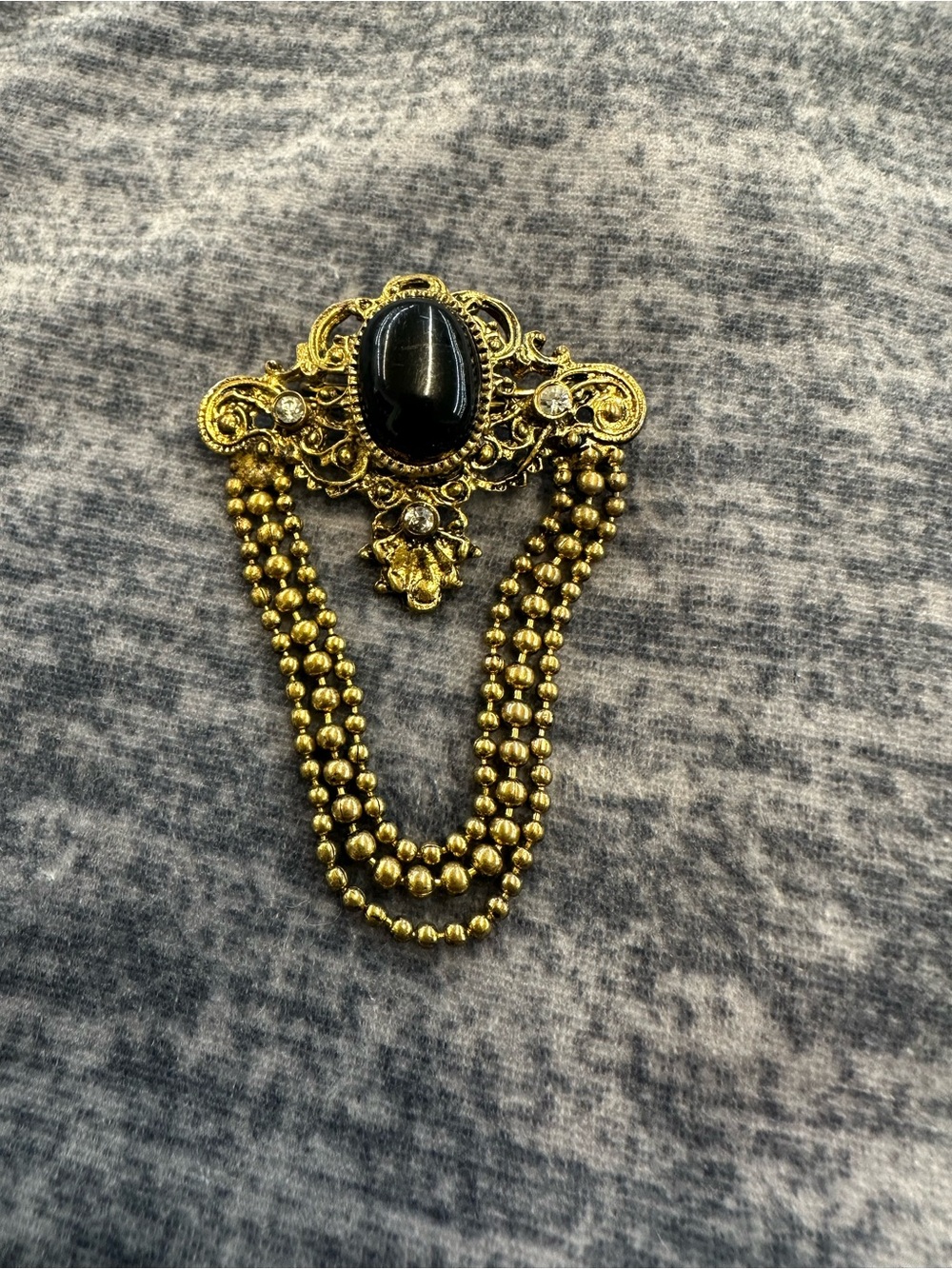 Gold tone black oval brooch vintage Germany made jewel dangle